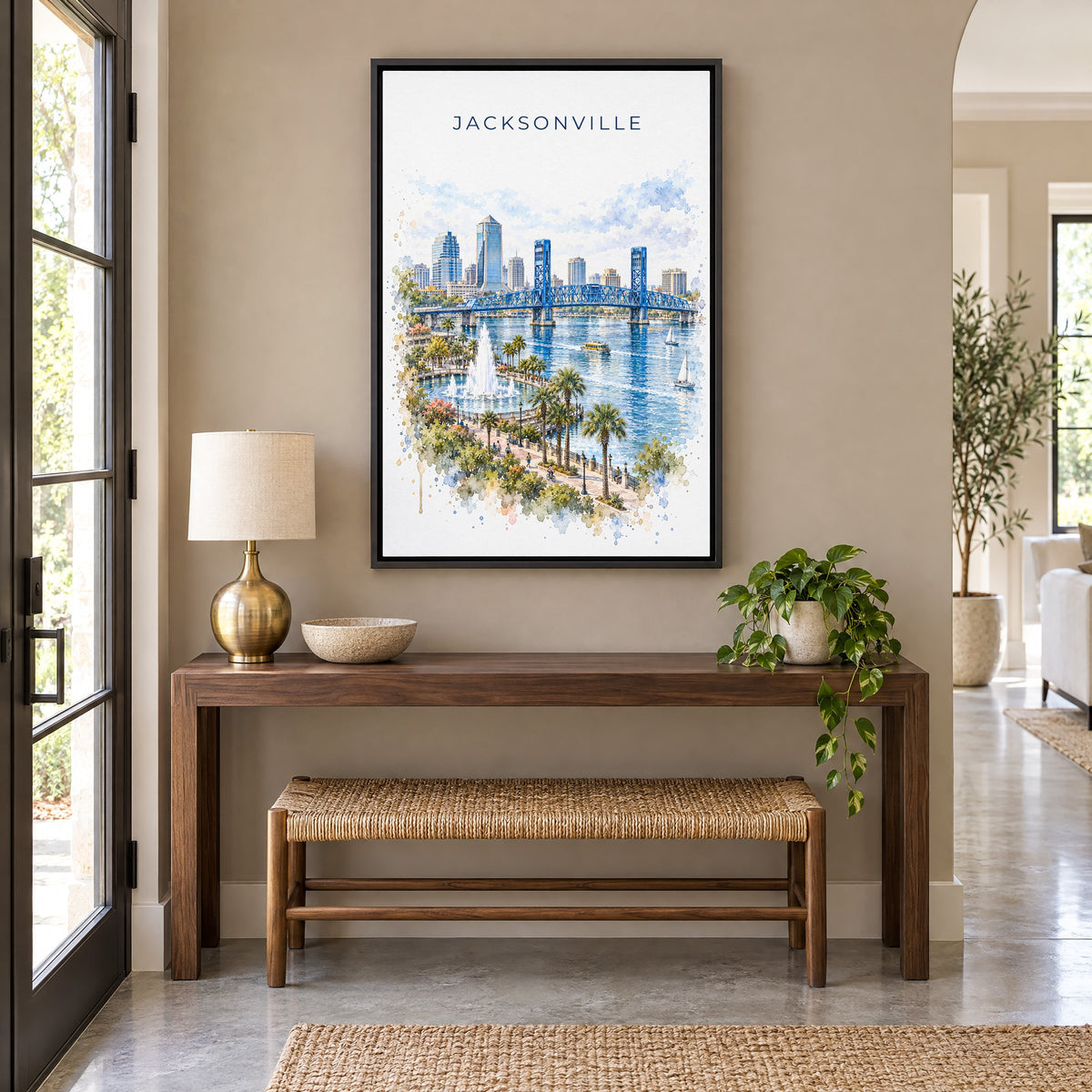 Jacksonville, Florida watercolor print as a black floater canvas above a walnut console and woven bench in an entryway