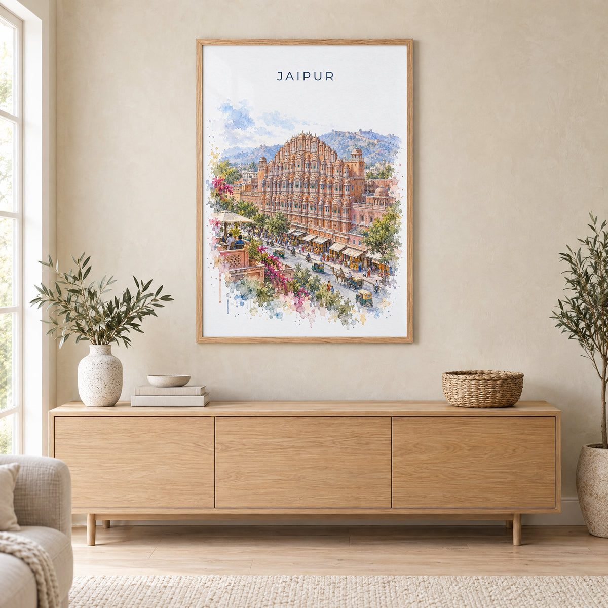 Jaipur watercolor print in an oak frame above a light wood sideboard in a Scandinavian living room