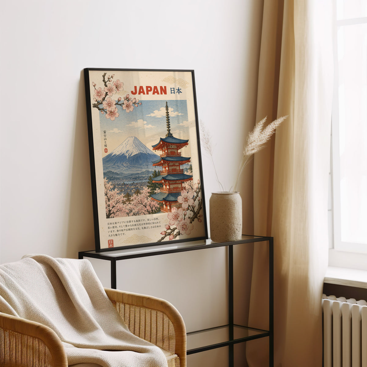 Mount Fuji, red pagoda and sakura print in a black frame leaning on a glass console beside pampas grass