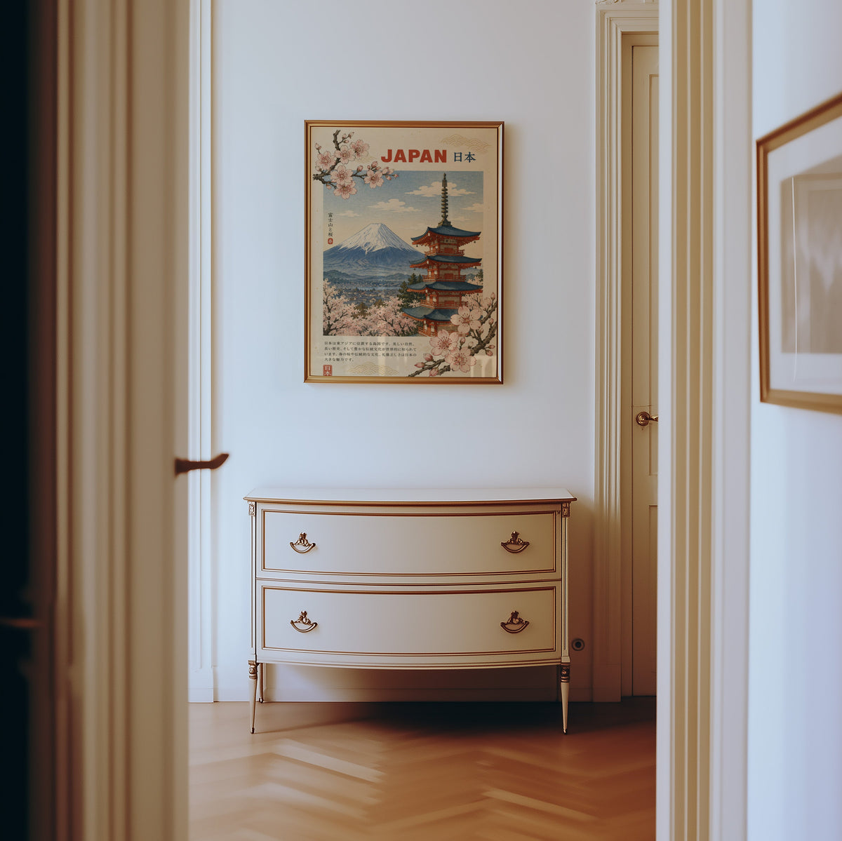 Mount Fuji, red pagoda and sakura print shown in a gold frame in a hallway above a cream dresser