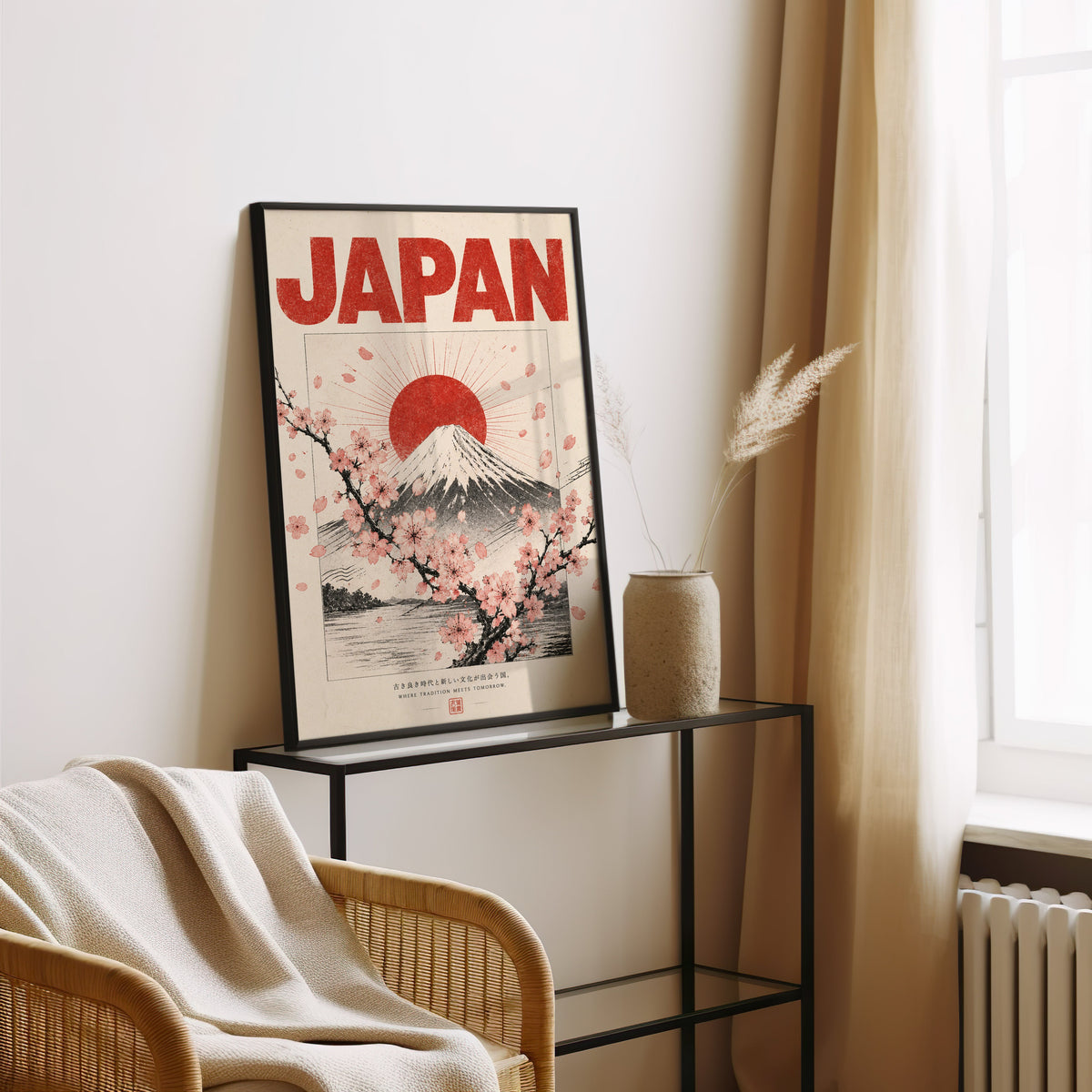 engraved Mount Fuji with sakura print in a black frame leaning on a glass console beside pampas grass
