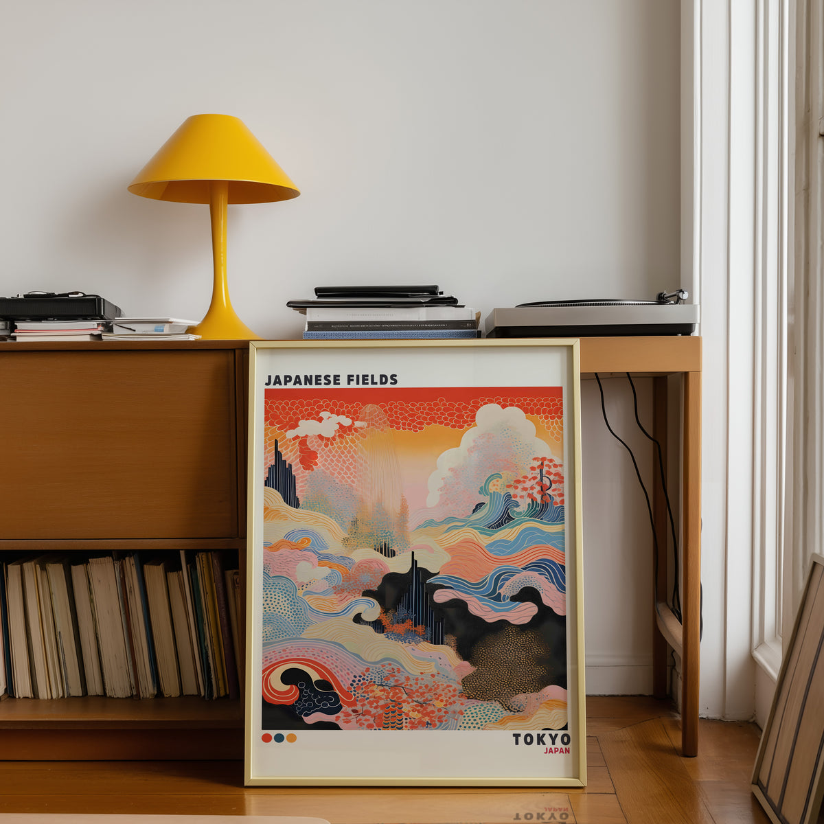 Japanese Fields abstract pattern landscape print shown in a gold frame below a teak desk with a yellow lamp
