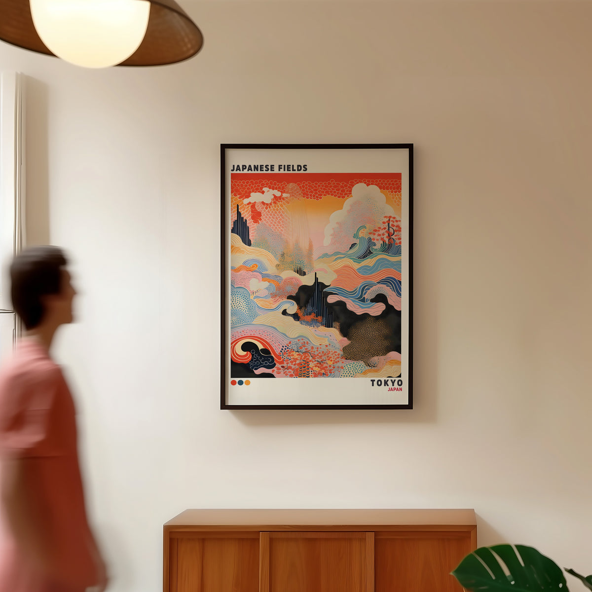 Japanese Fields abstract pattern landscape print in a black frame in a hallway under a rattan pendant