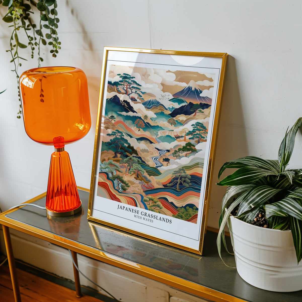 Japanese Grasslands with Waves Fuji print shown in a gold frame on a console beside an orange glass lamp