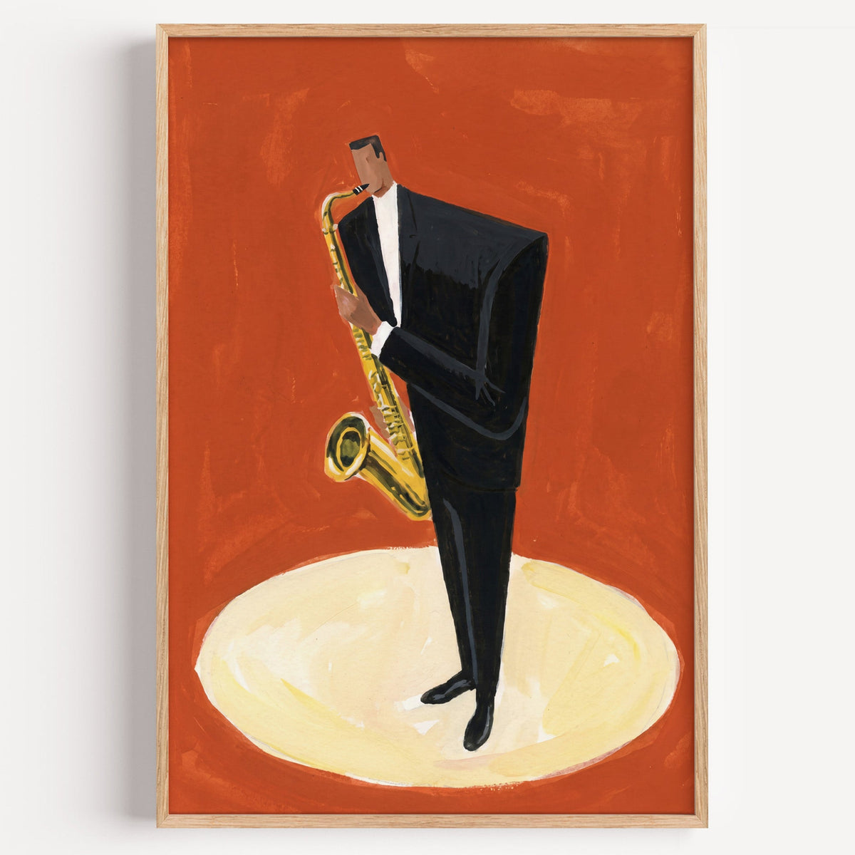 Jazz saxophone player print in a light oak frame on a plain white wall