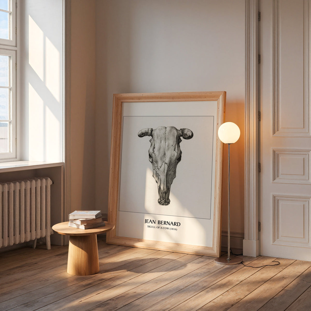 Cow skull print in a wide pine frame leaning by a sunlit window