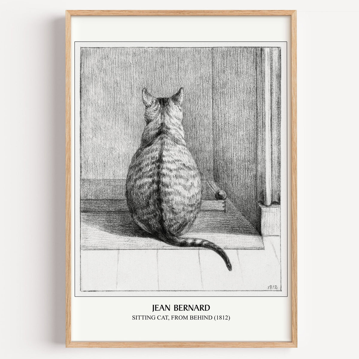 Jean Bernard Sitting Cat drawing print in a light oak frame on a white wall