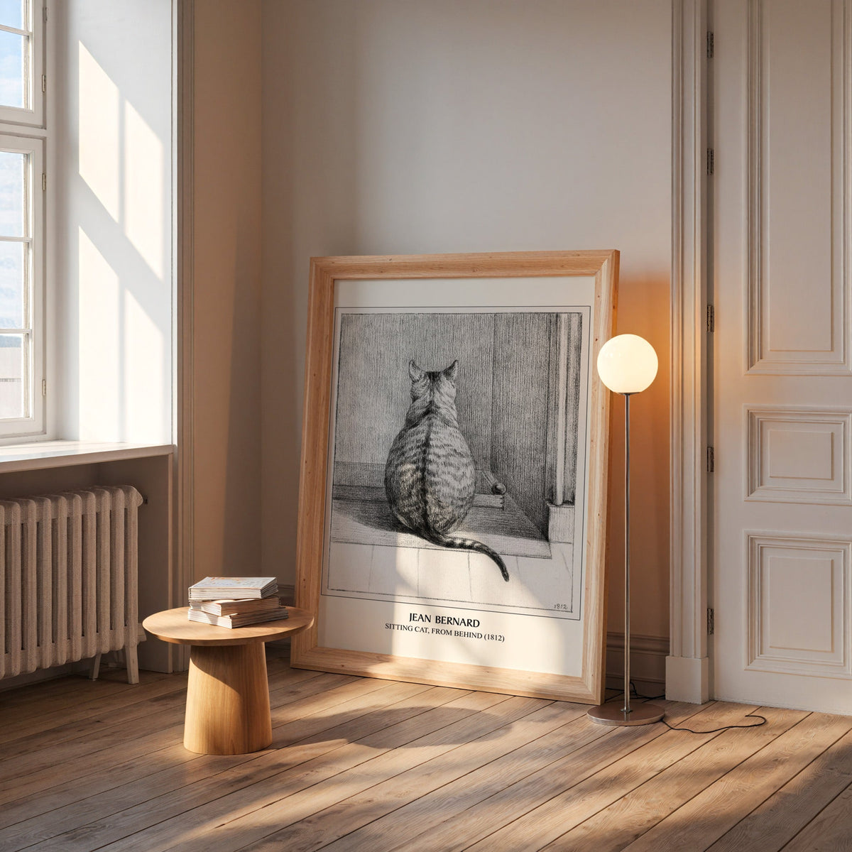 Bernard cat print in a wide pine frame leaning by a sunlit window