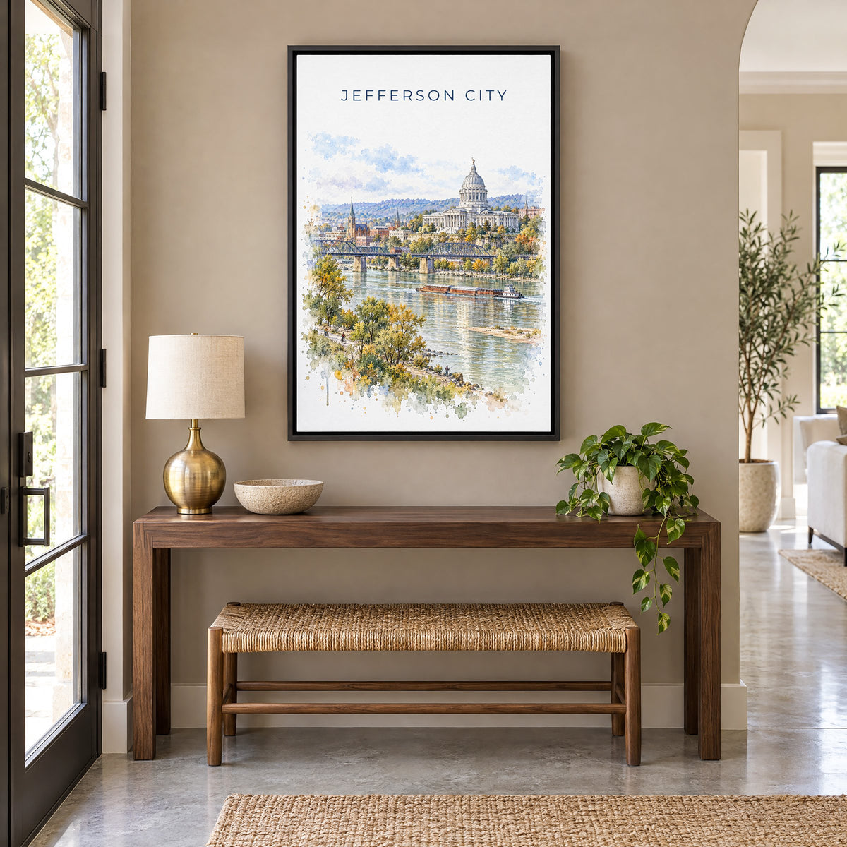 Jefferson City watercolor print as a black floater canvas above a walnut console and woven bench in an entryway