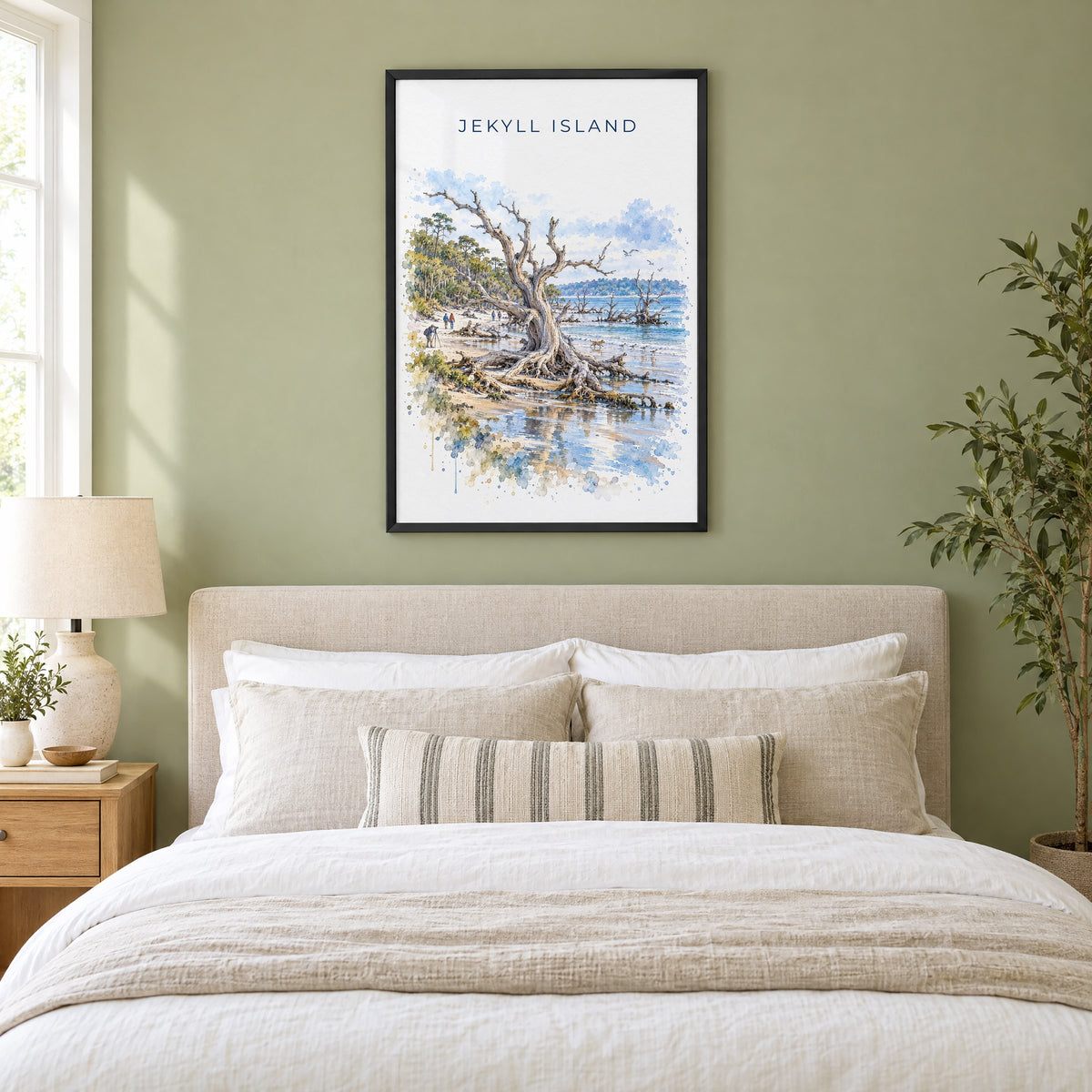 Jekyll Island watercolor print in a black frame above an upholstered headboard in a sage green bedroom