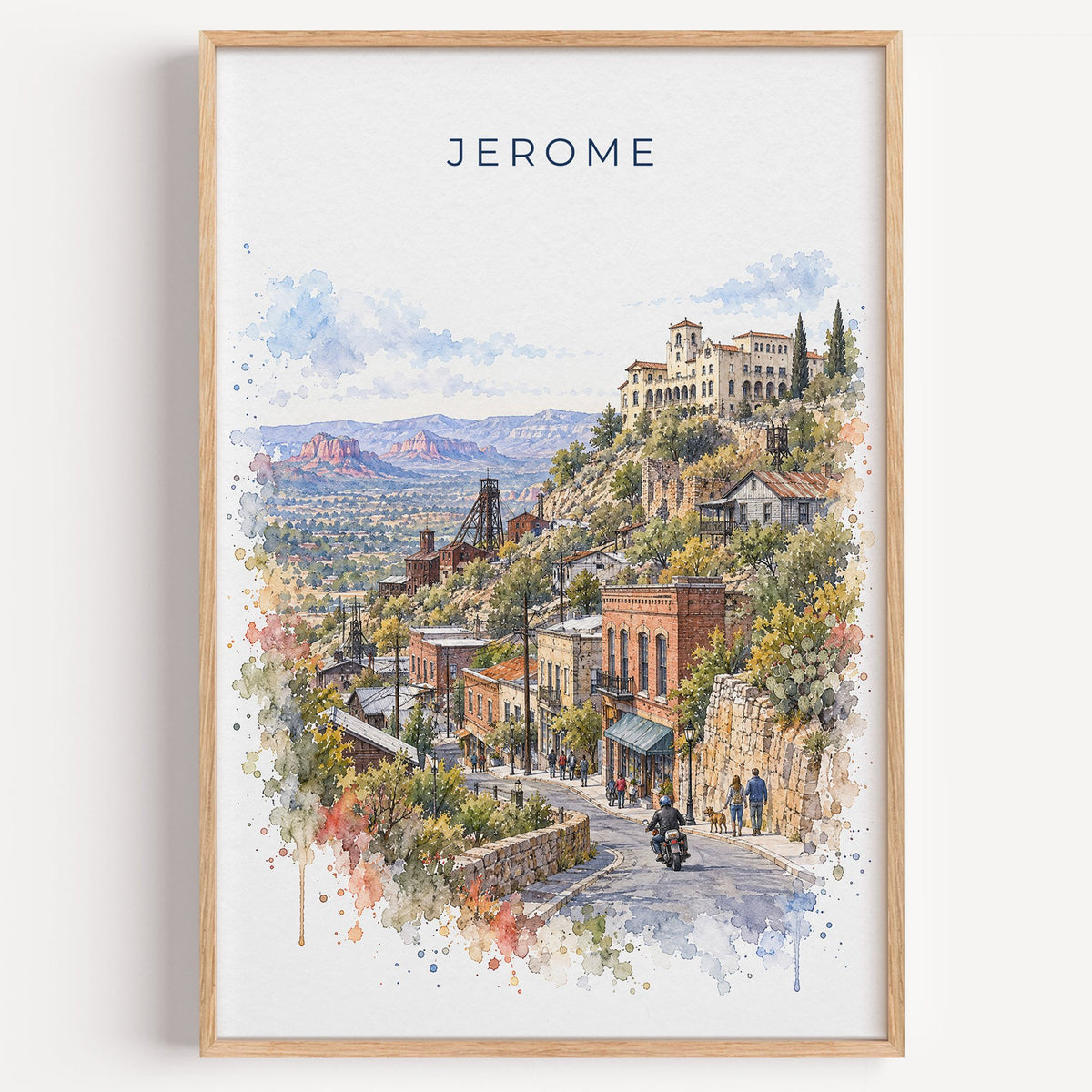 Jerome, Arizona watercolor print in a light oak frame on a plain white wall
