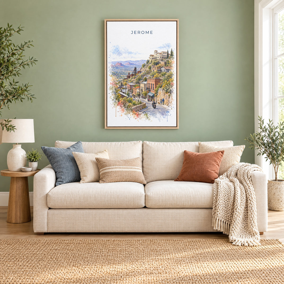 Jerome, Arizona watercolor print as a natural floater canvas above a cream linen sofa on a sage green wall
