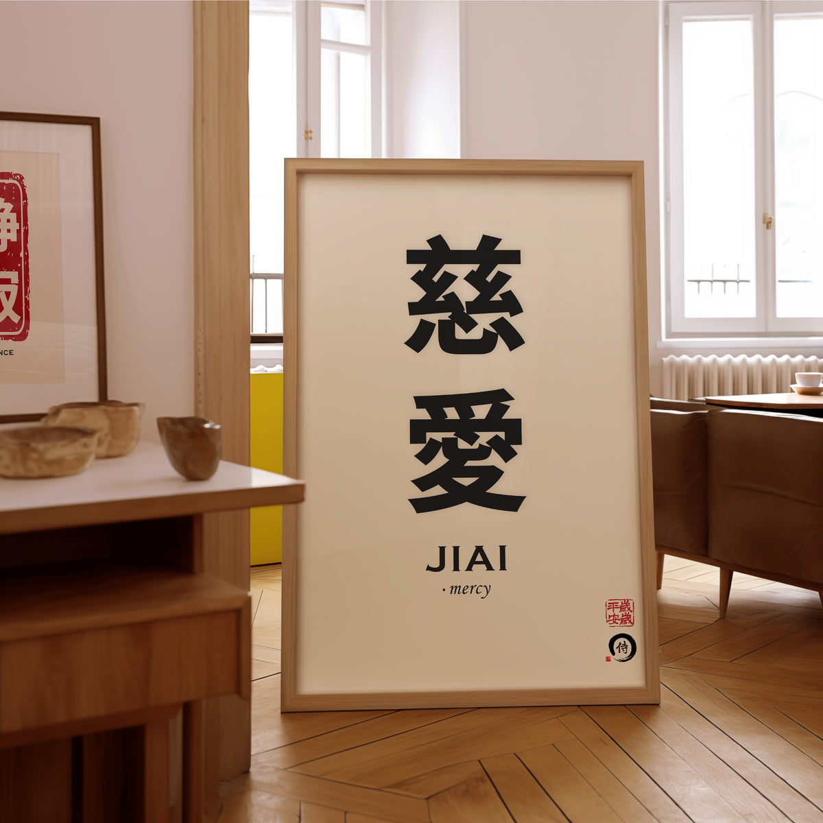 Jiai mercy kanji print in an oak frame on the parquet floor of a sunlit living room