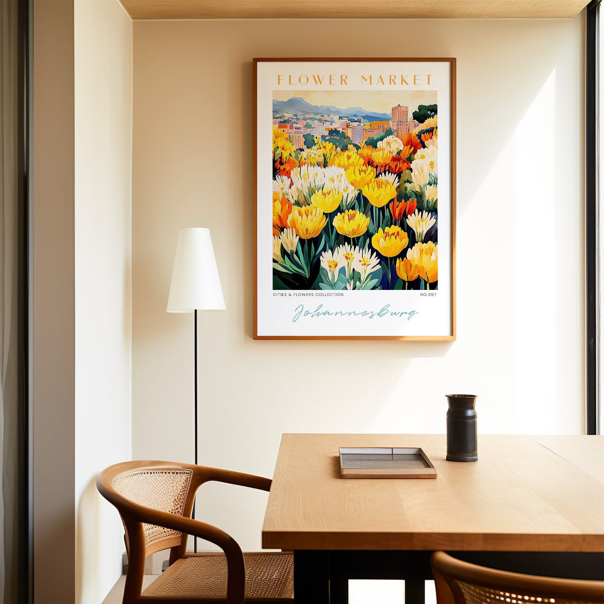 Johannesburg flower market print in an oak frame above a dining table and cane chair