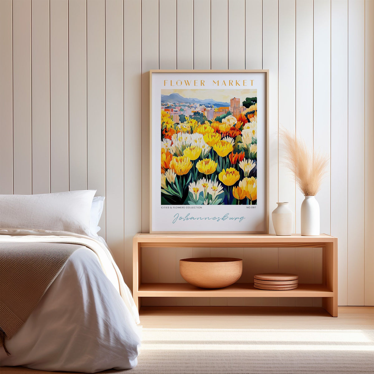 Johannesburg flower market print in an oak frame on a wood bench against a white shiplap bedroom wall with pampas grass