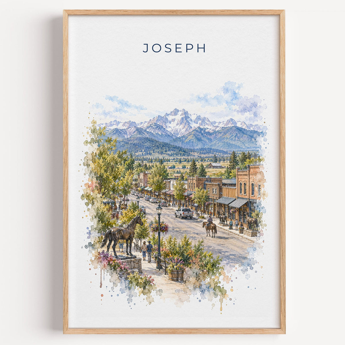 Joseph, Oregon watercolor print in a light oak frame on a plain white wall
