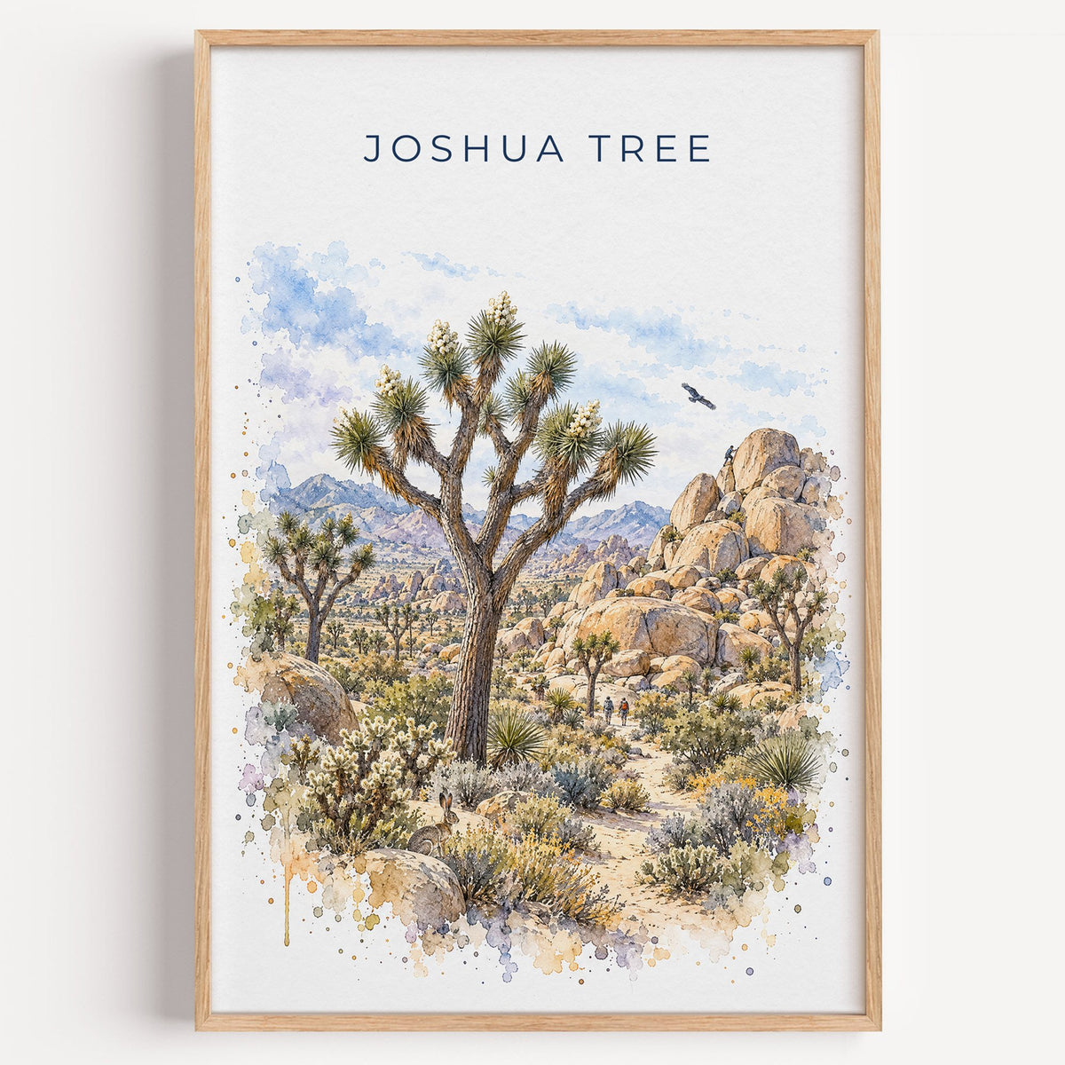 Joshua Tree National Park watercolor print in a light oak frame on a plain white wall
