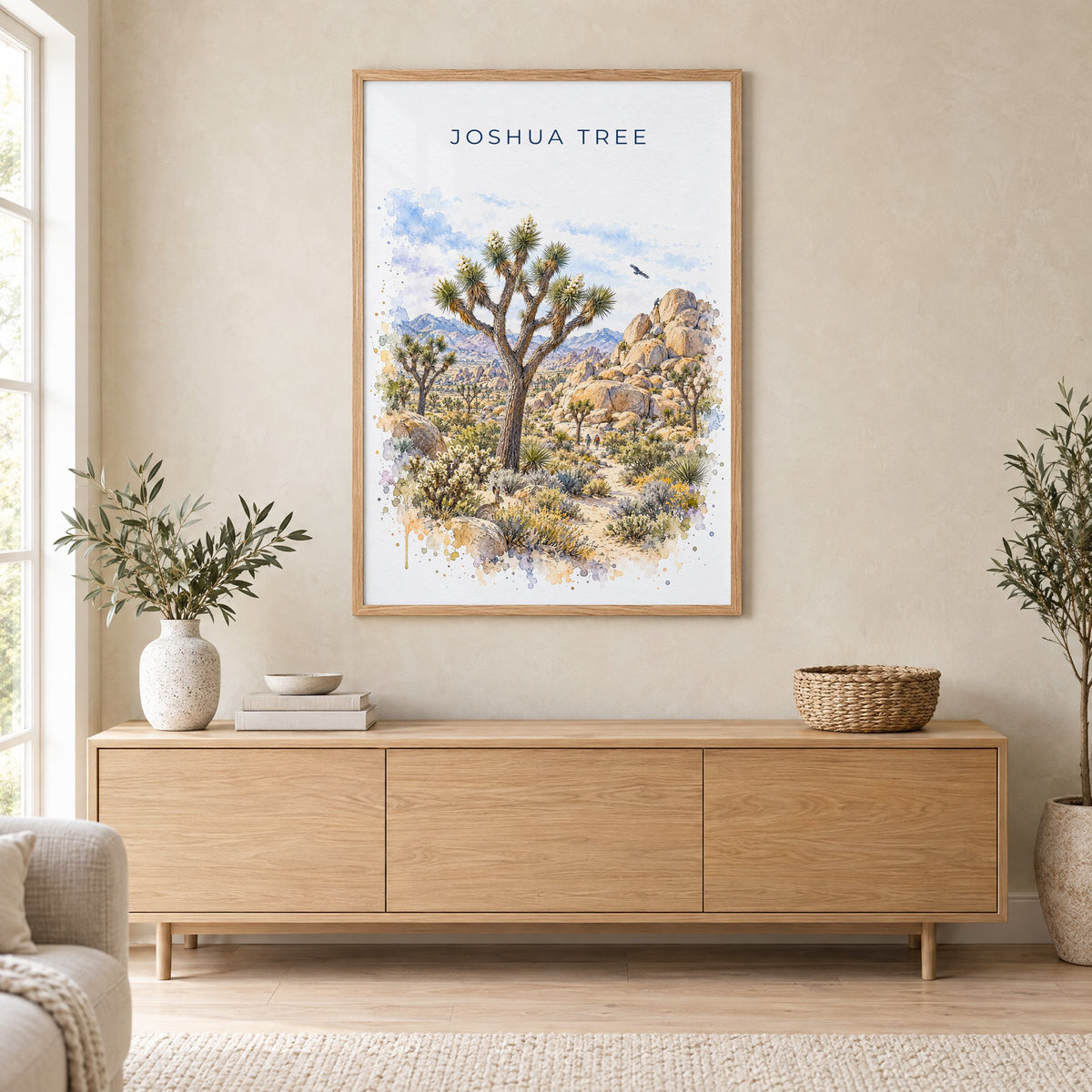 Joshua Tree National Park watercolor print in an oak frame above a light wood sideboard in a Scandinavian living room