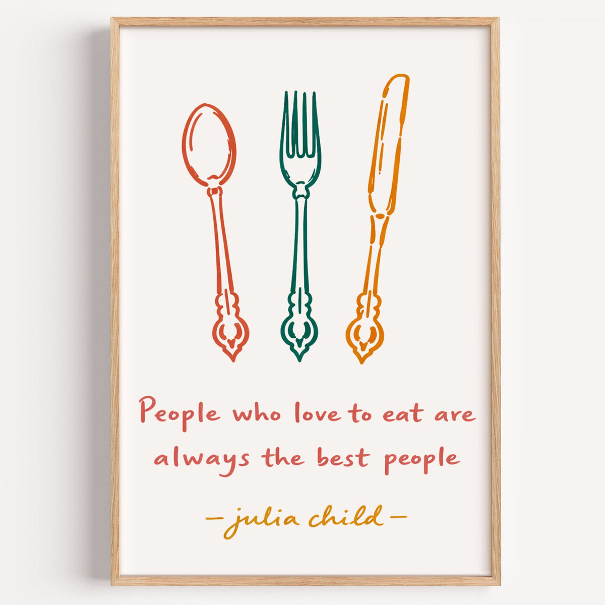 Julia Child quote cutlery print in a light oak frame on a plain white wall