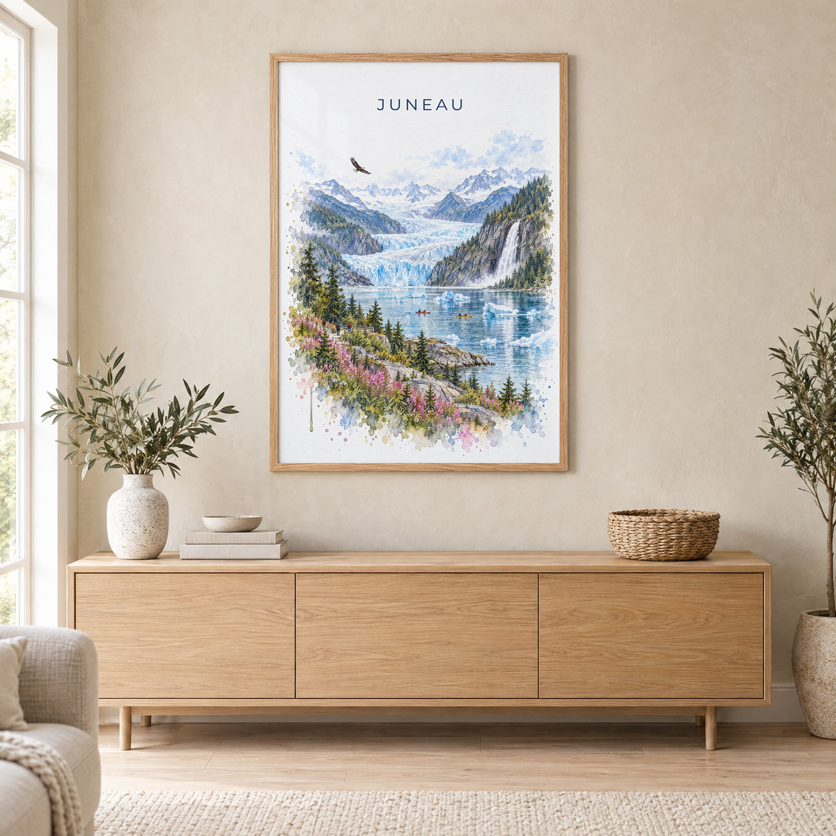 Juneau watercolor print in an oak frame above a light wood sideboard in a Scandinavian living room