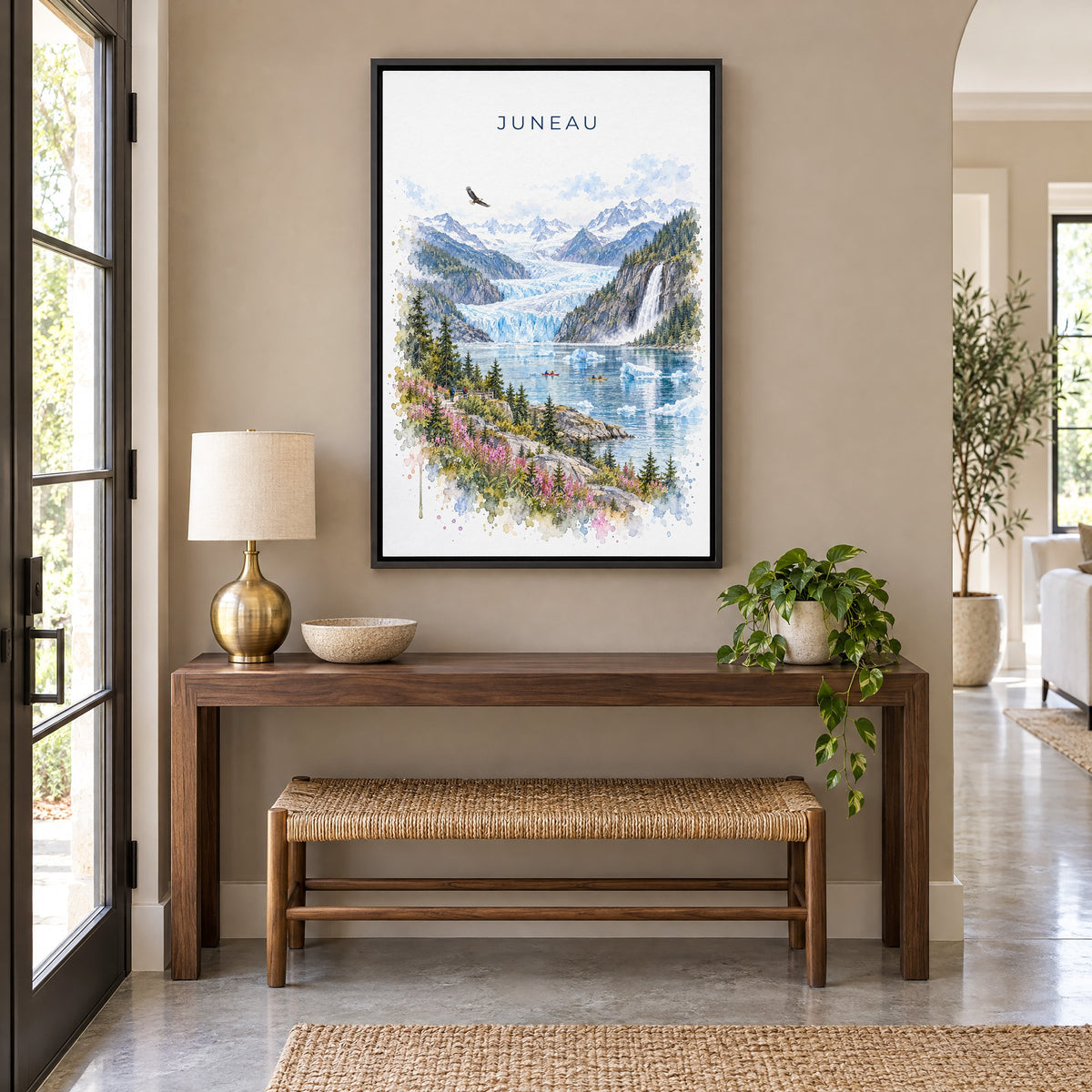 Juneau watercolor print as a black floater canvas above a walnut console and woven bench in an entryway