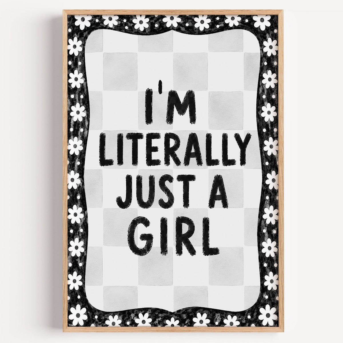 I'm literally just a girl quote with daisy border print in a light oak frame on a plain white wall