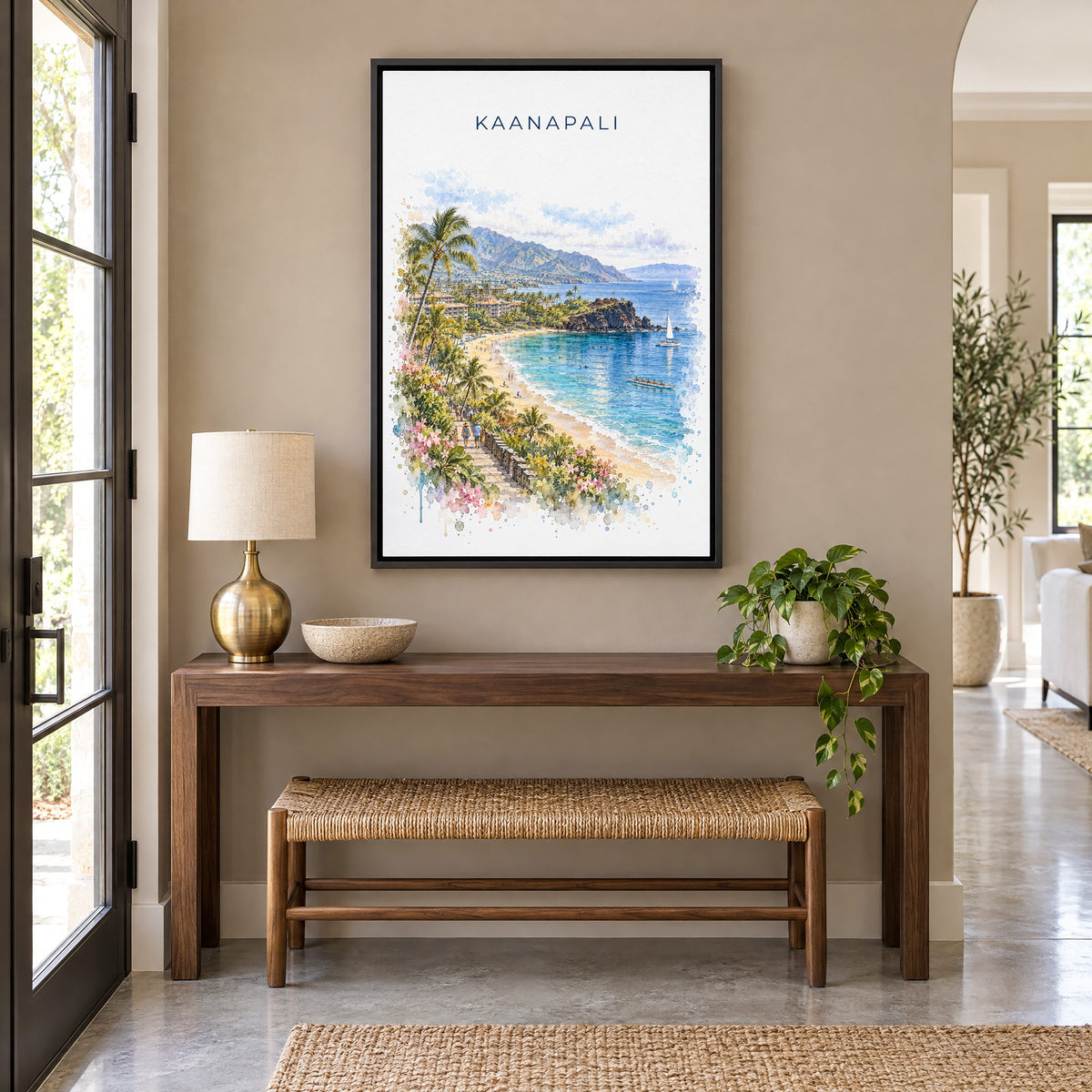 Kaanapali watercolor print as a black floater canvas above a walnut console and woven bench in an entryway