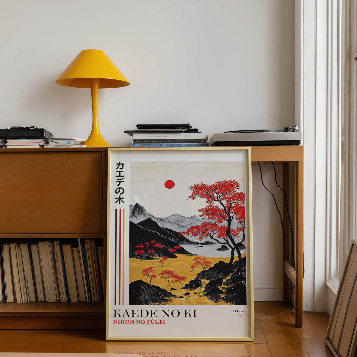 Kaede red maple tree landscape print shown in a gold frame below a teak desk with a yellow lamp