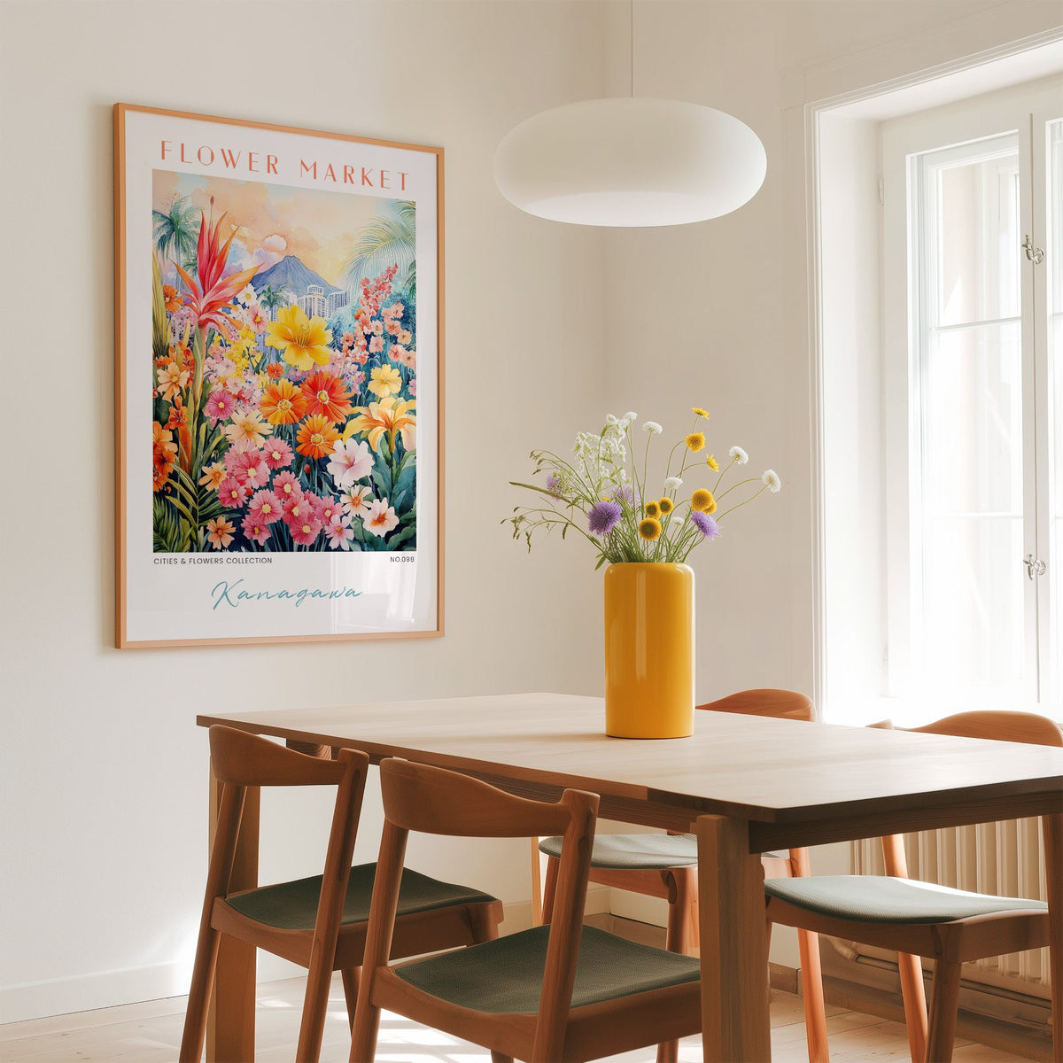 Kanagawa flower market print in an oak frame above a dining table with a yellow vase and white pendant light