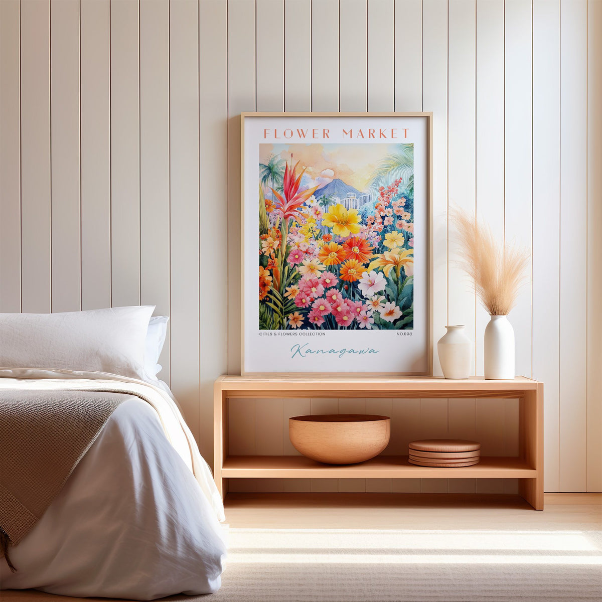 Kanagawa flower market print in an oak frame on a wood bench against a white shiplap bedroom wall with pampas grass