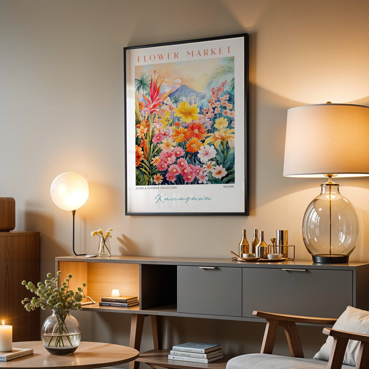 Kanagawa flower market print in a black frame above a grey media console with a glass table lamp