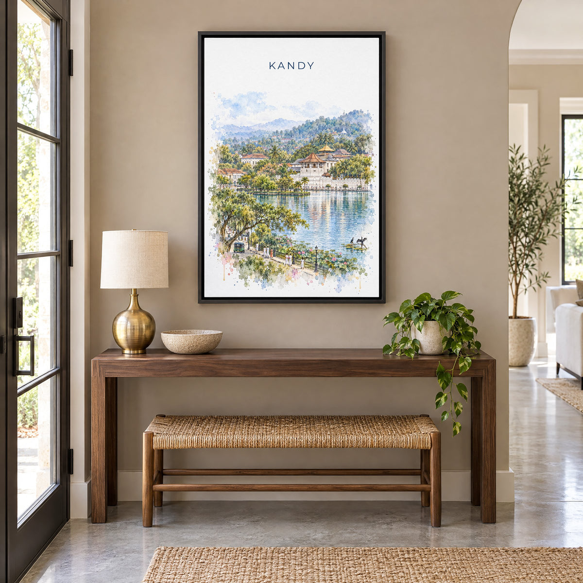 Kandy, Sri Lanka watercolor print as a black floater canvas above a walnut console and woven bench in an entryway