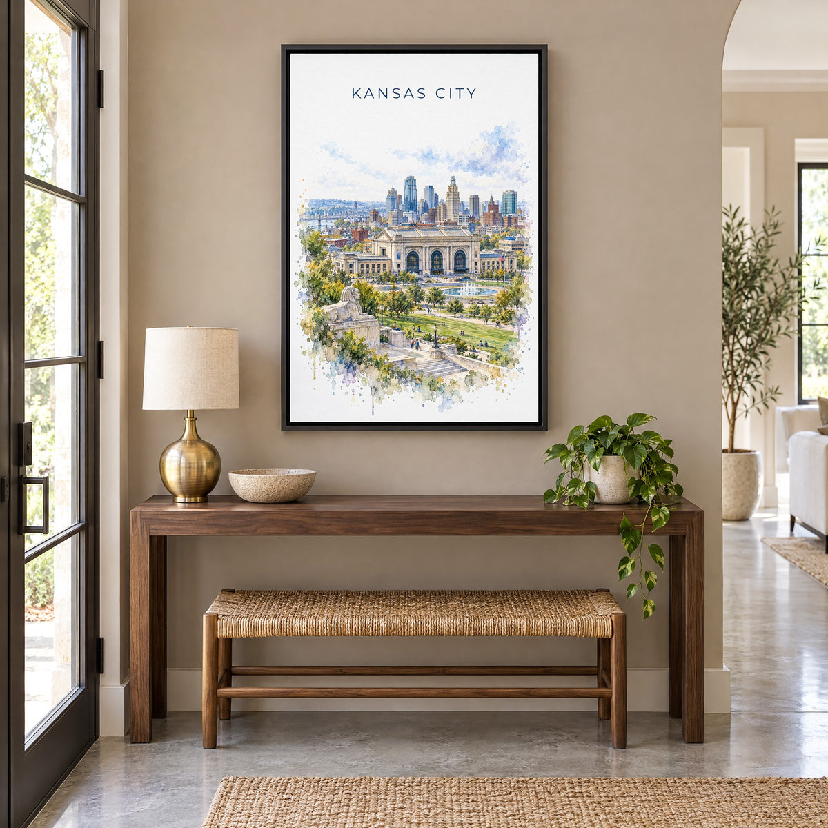 Kansas City watercolor print as a black floater canvas above a walnut console and woven bench in an entryway