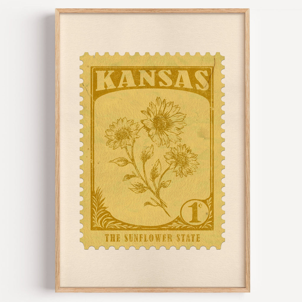 Kansas state flower stamp print in ochre gold on straw, light oak frame on a plain white wall