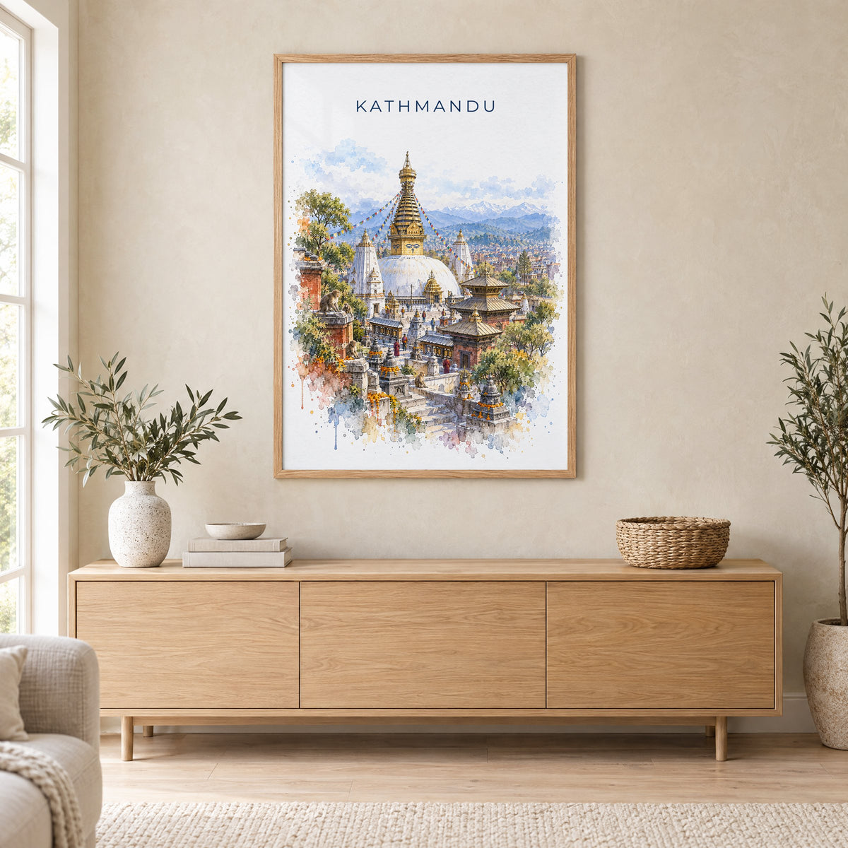 Kathmandu watercolor print in an oak frame above a light wood sideboard in a Scandinavian living room