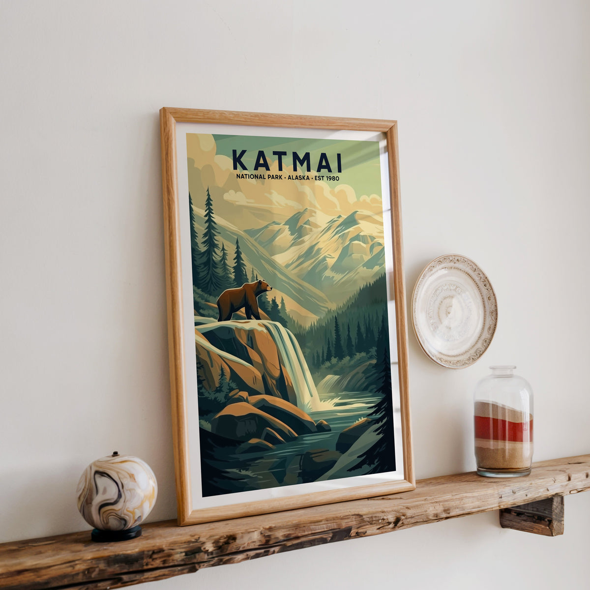 Katmai National Park print in an oak frame on a rustic wood shelf with ceramics and a sand-filled jar
