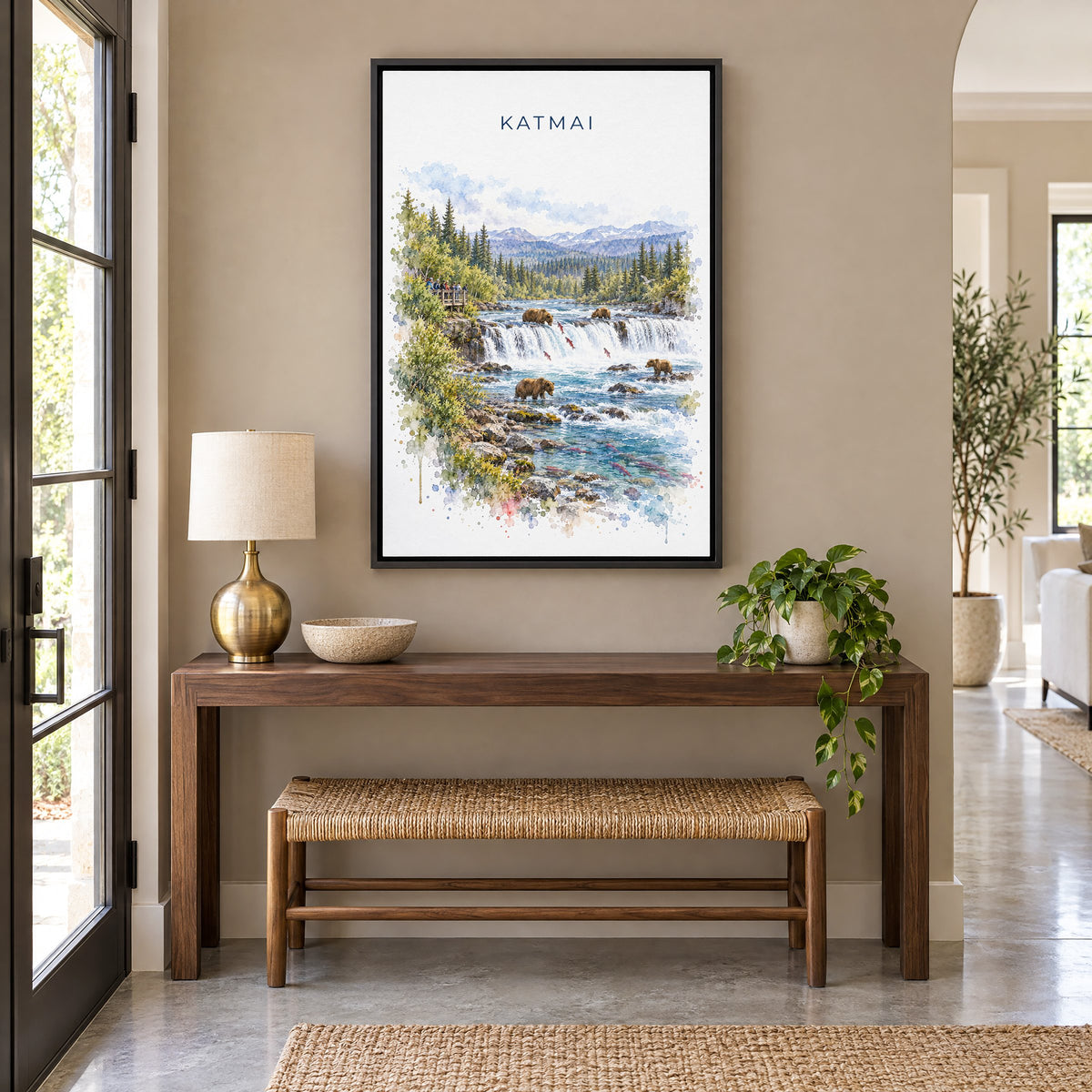 Katmai National Park watercolor print as a black floater canvas above a walnut console and woven bench in an entryway