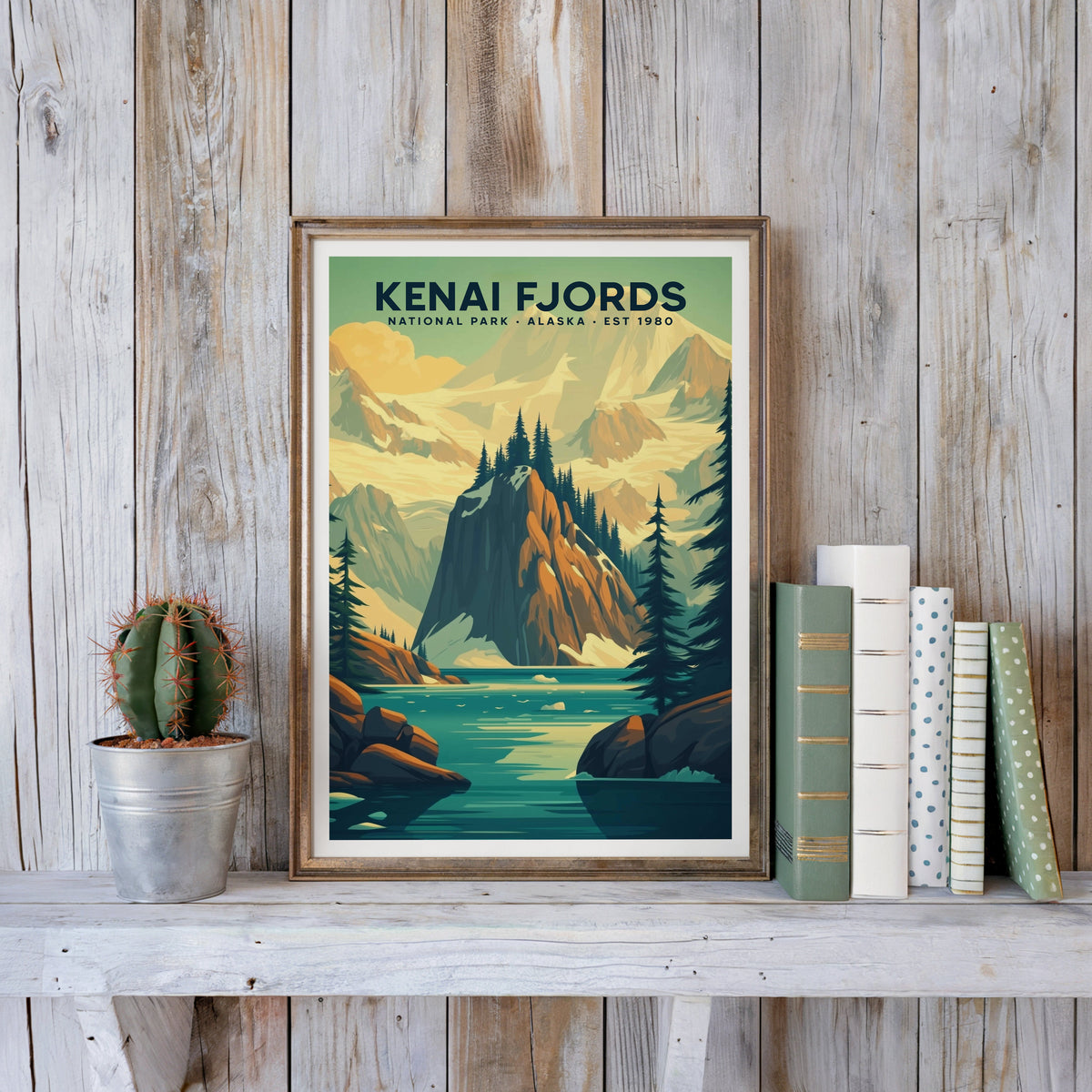Kenai Fjords poster in an antique gold frame against whitewashed farmhouse planks beside books and a cactus