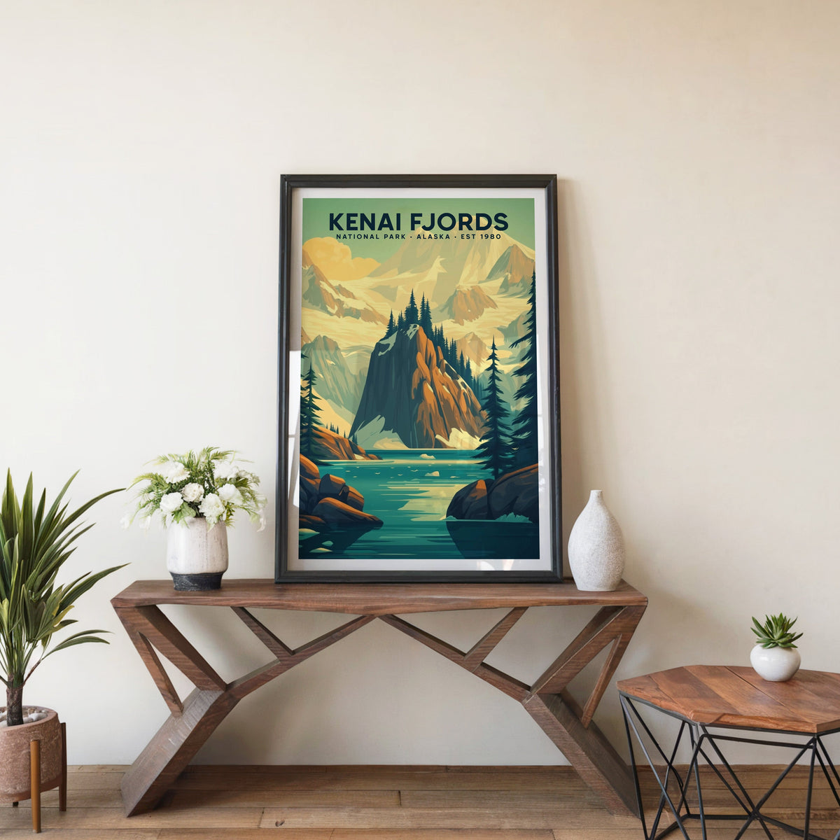Kenai Fjords poster in a black frame on an entryway console table beside white flowers and a yucca