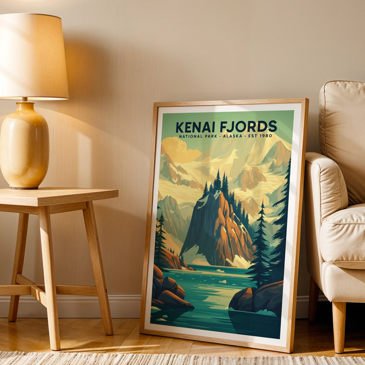 Kenai Fjords print in an oak frame beside a cream armchair and an amber lamp in warm afternoon light