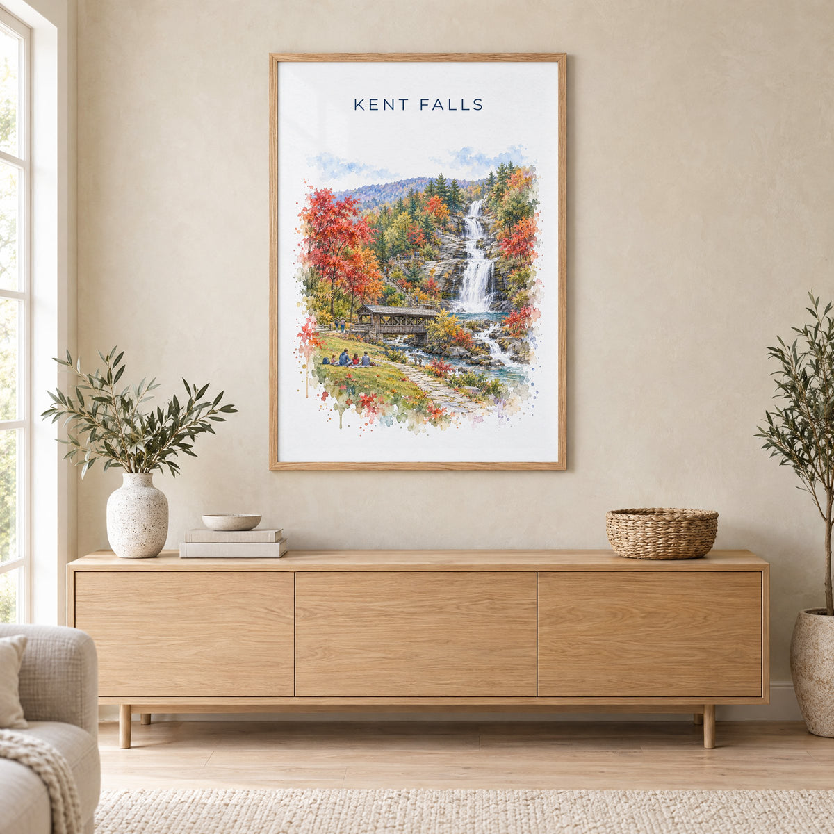 Kent Falls State Park watercolor print in an oak frame above a light wood sideboard in a Scandinavian living room