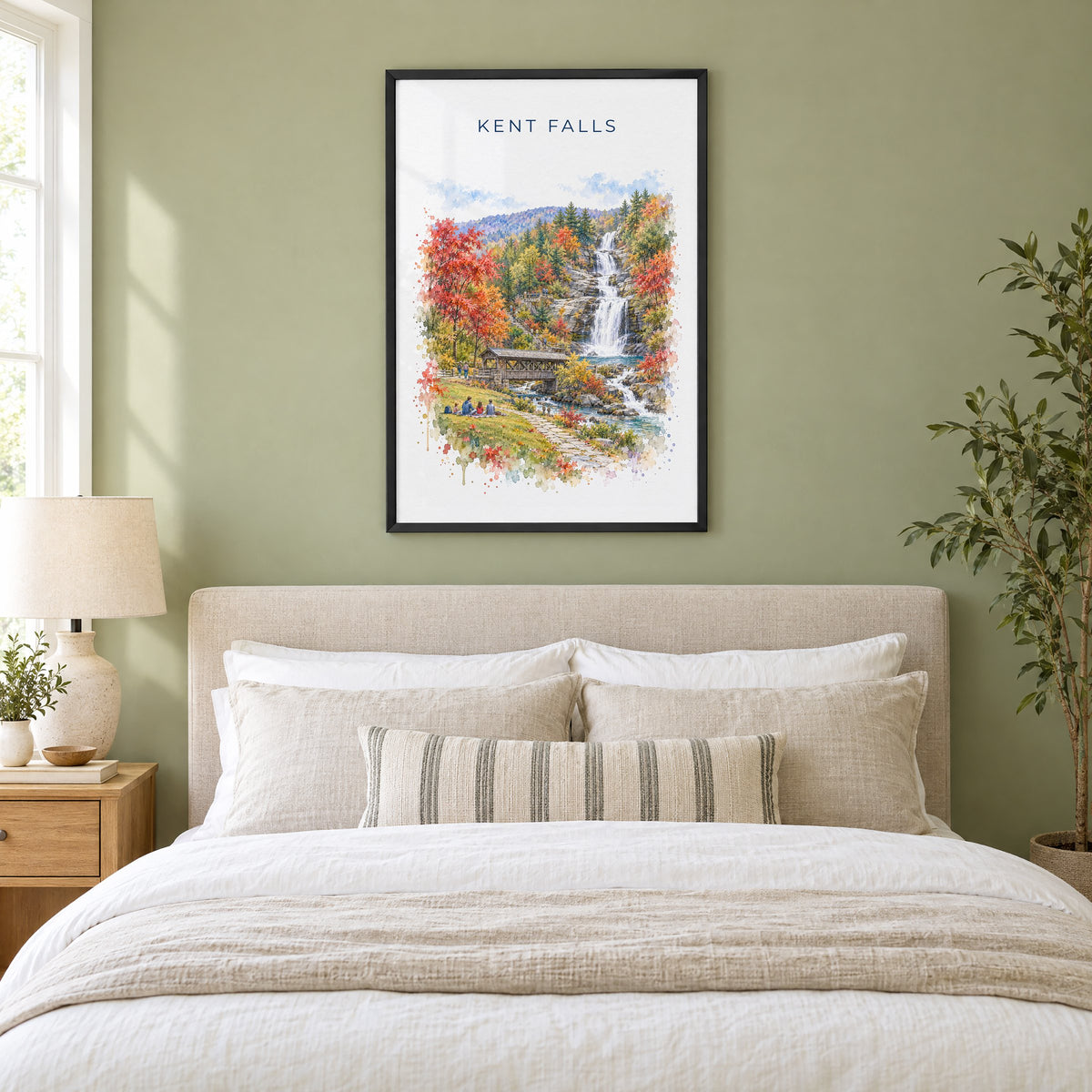 Kent Falls State Park watercolor print in a black frame above an upholstered headboard in a sage green bedroom