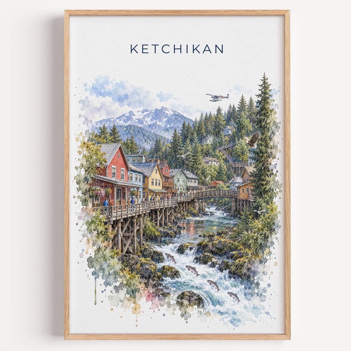 Ketchikan watercolor print in a light oak frame on a plain white wall