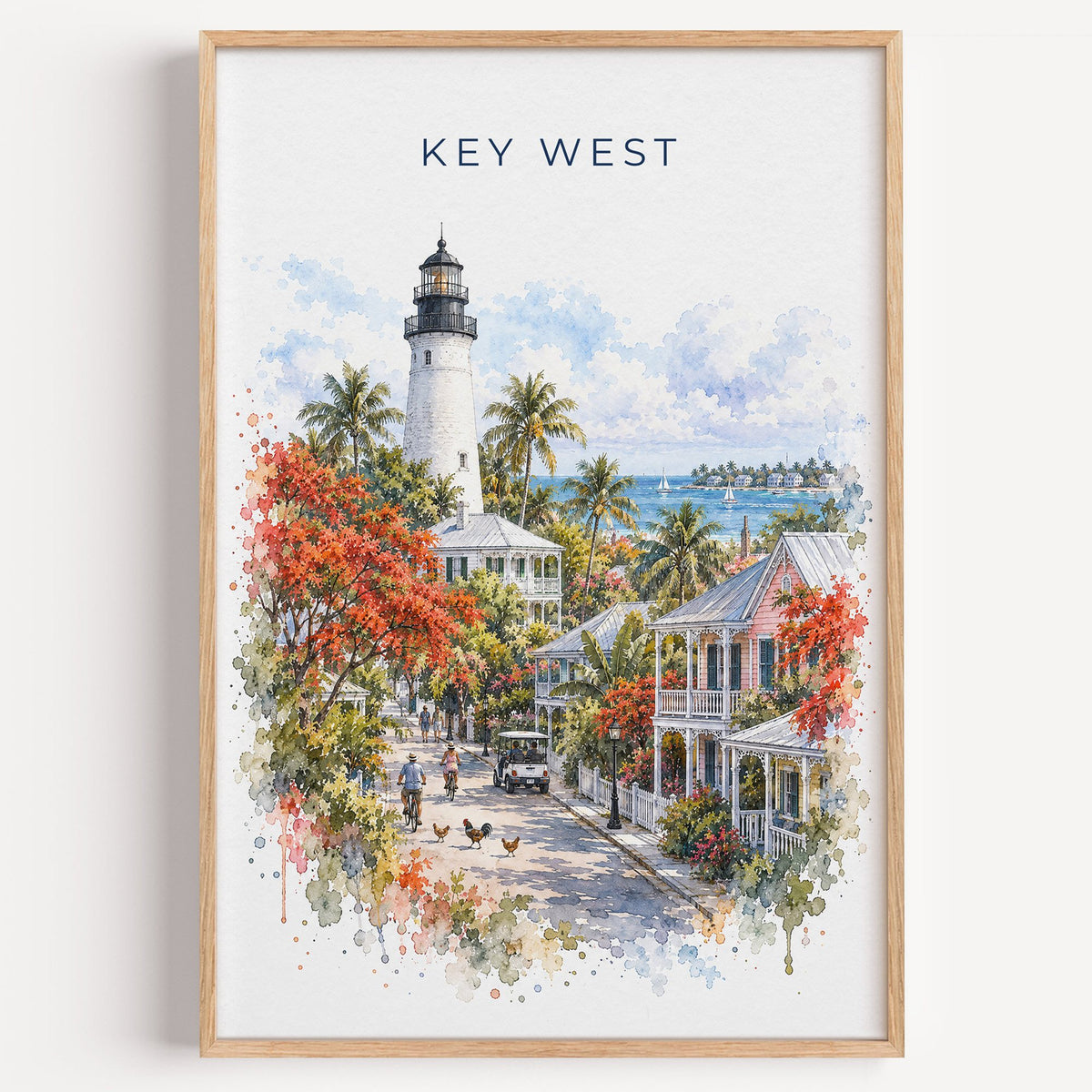Key West watercolor print in a light oak frame on a plain white wall