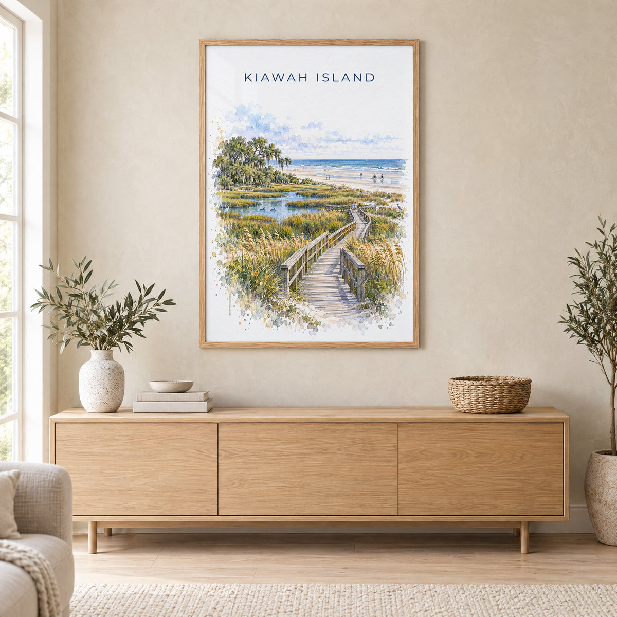 Kiawah Island watercolor print in an oak frame above a light wood sideboard in a Scandinavian living room