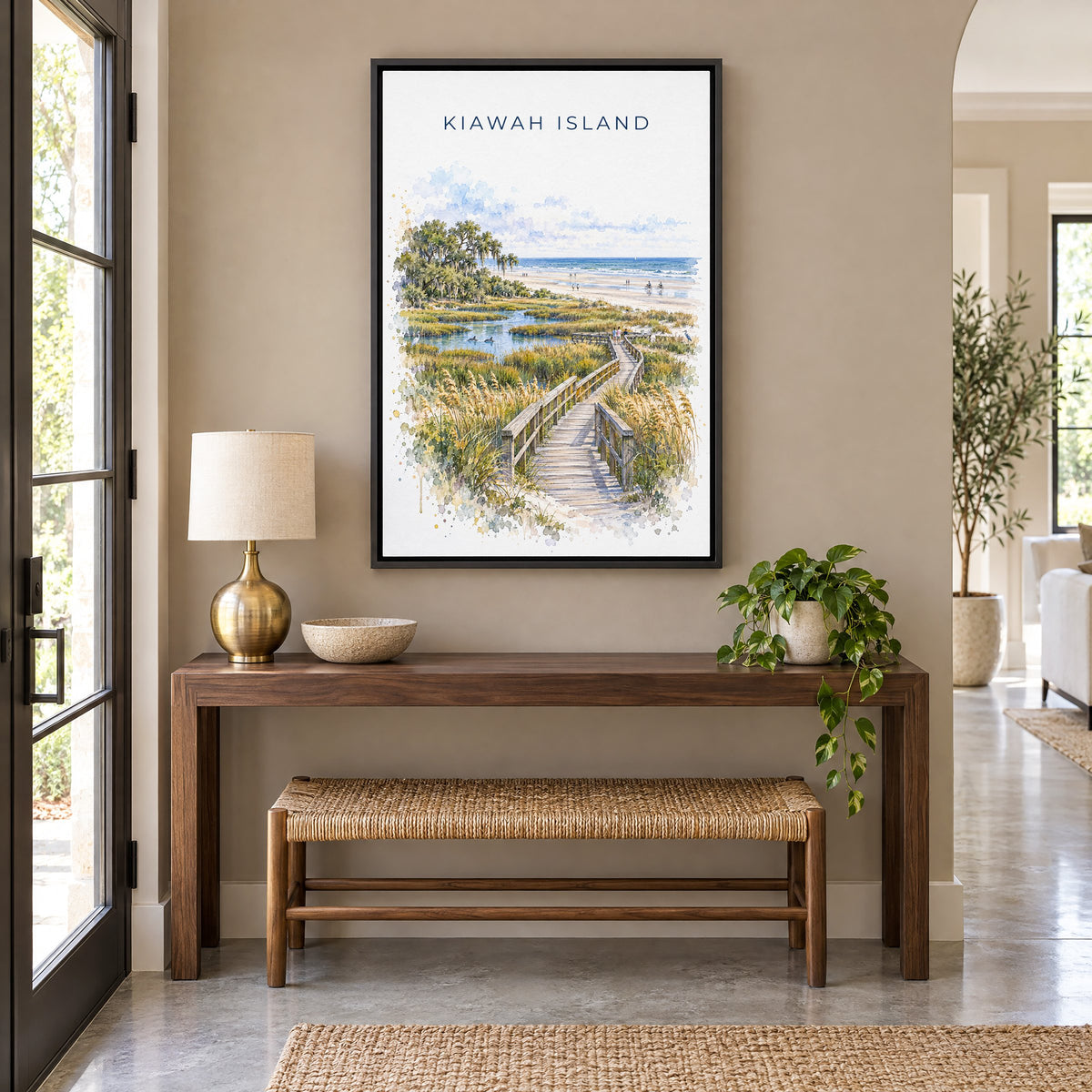 Kiawah Island watercolor print as a black floater canvas above a walnut console and woven bench in an entryway