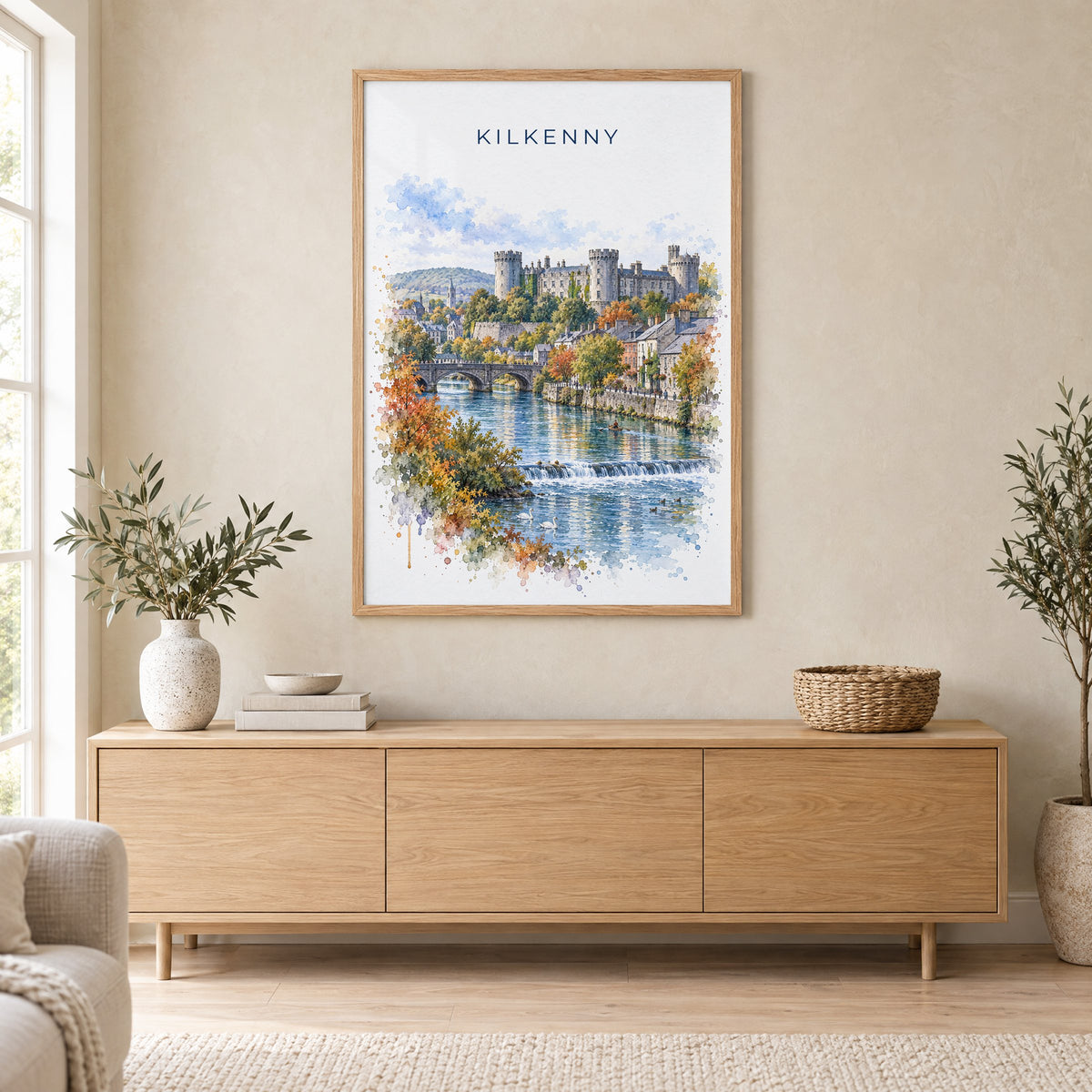 Kilkenny watercolor print in an oak frame above a light wood sideboard in a Scandinavian living room