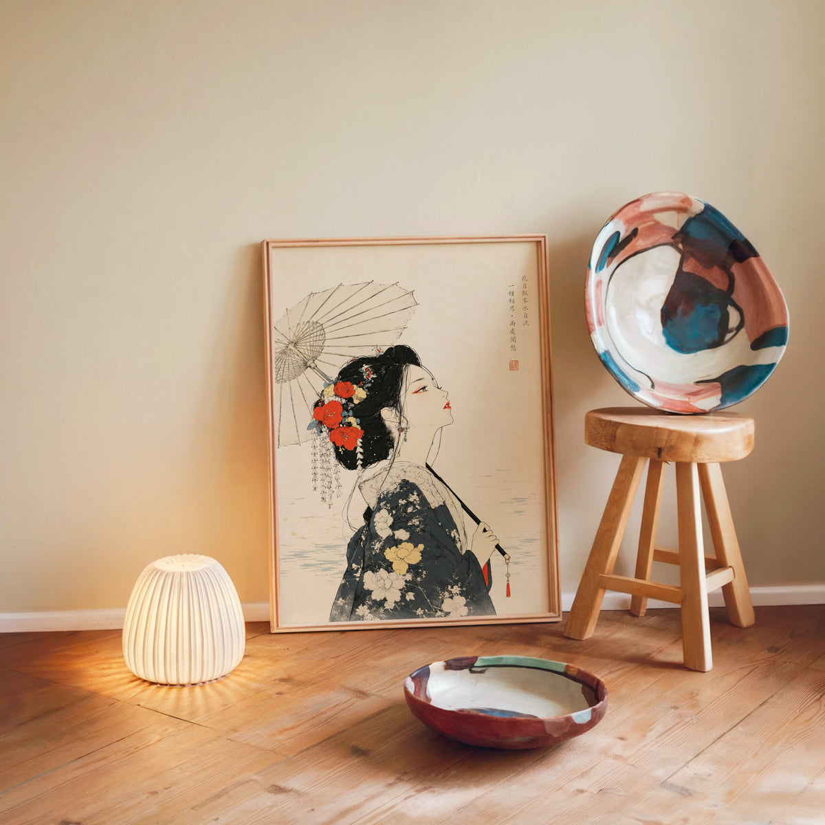 kimono woman with parasol and red flowers print in a light wood frame leaning on a wooden floor by a glowing lamp and stool