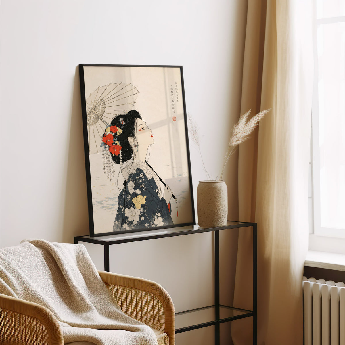 kimono woman with parasol and red flowers print in a black frame leaning on a glass console beside pampas grass