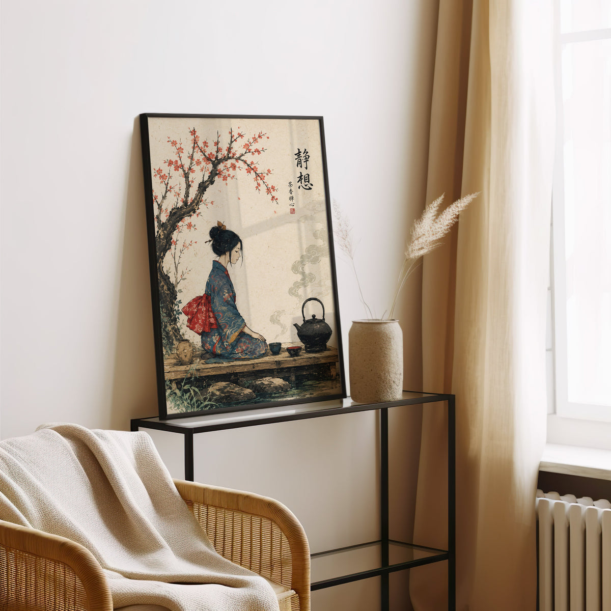 kimono woman with iron tea kettle print in a black frame leaning on a glass console beside pampas grass